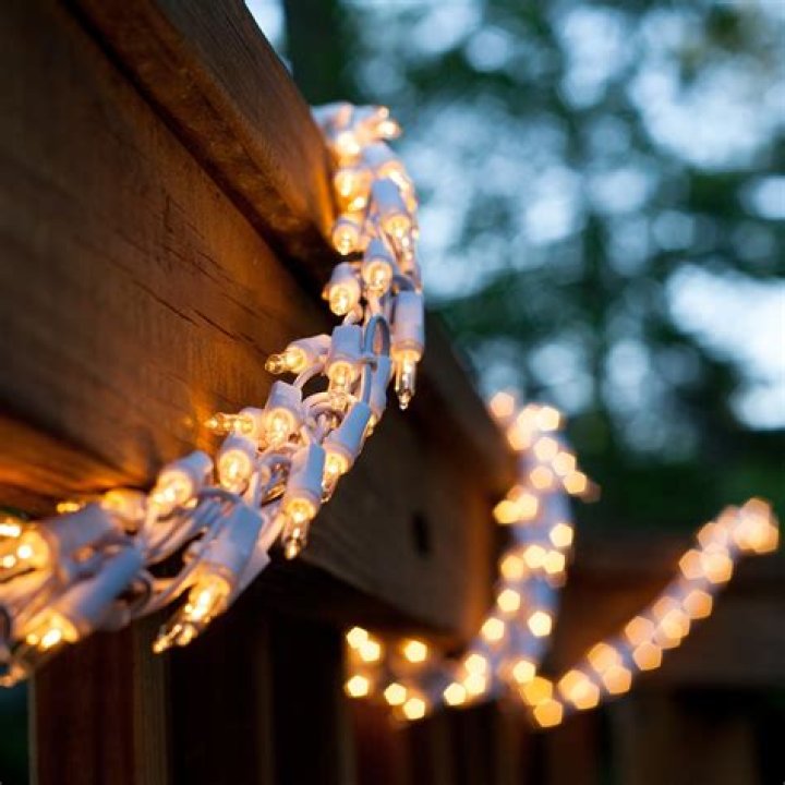 A white garland and lights festive background.